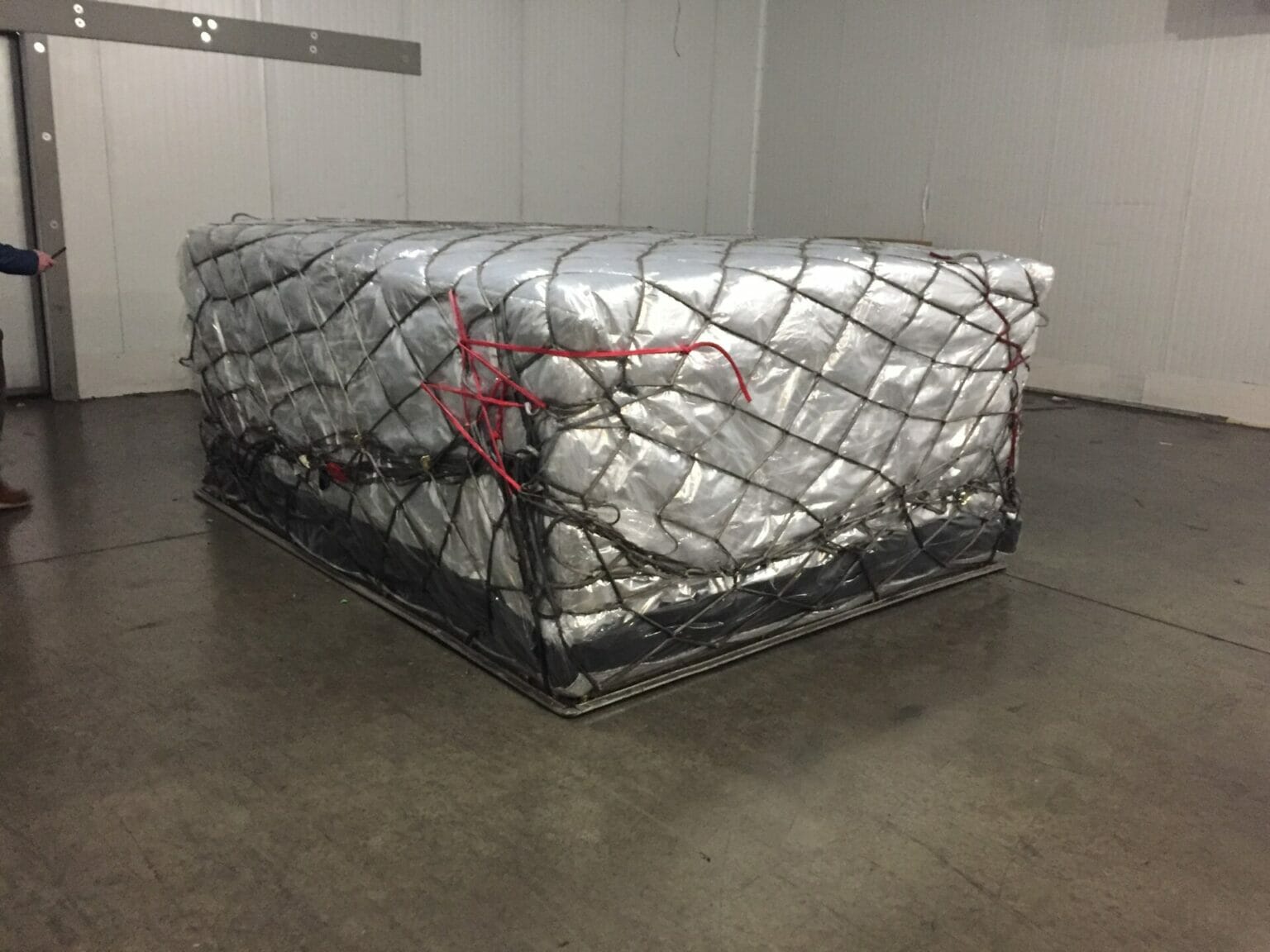 Insulated air cargo load secured with a freight net, pictured by QProducts & Services